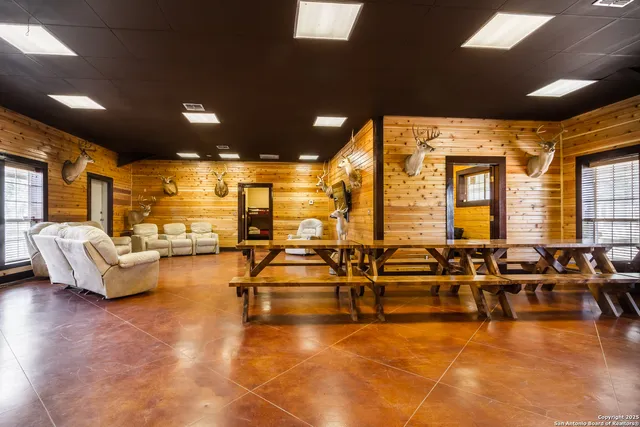 a living room with lots of furniture and a large window