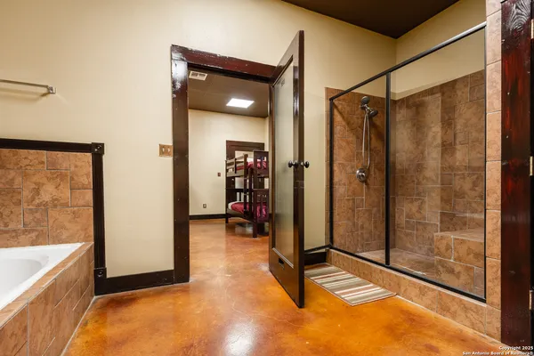 a view of a bathroom with tub and shower