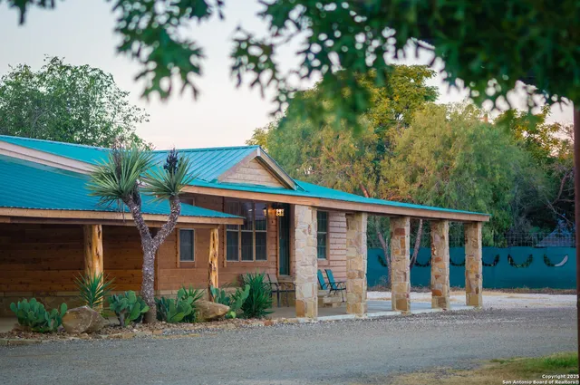 a view of a house with a tree in front