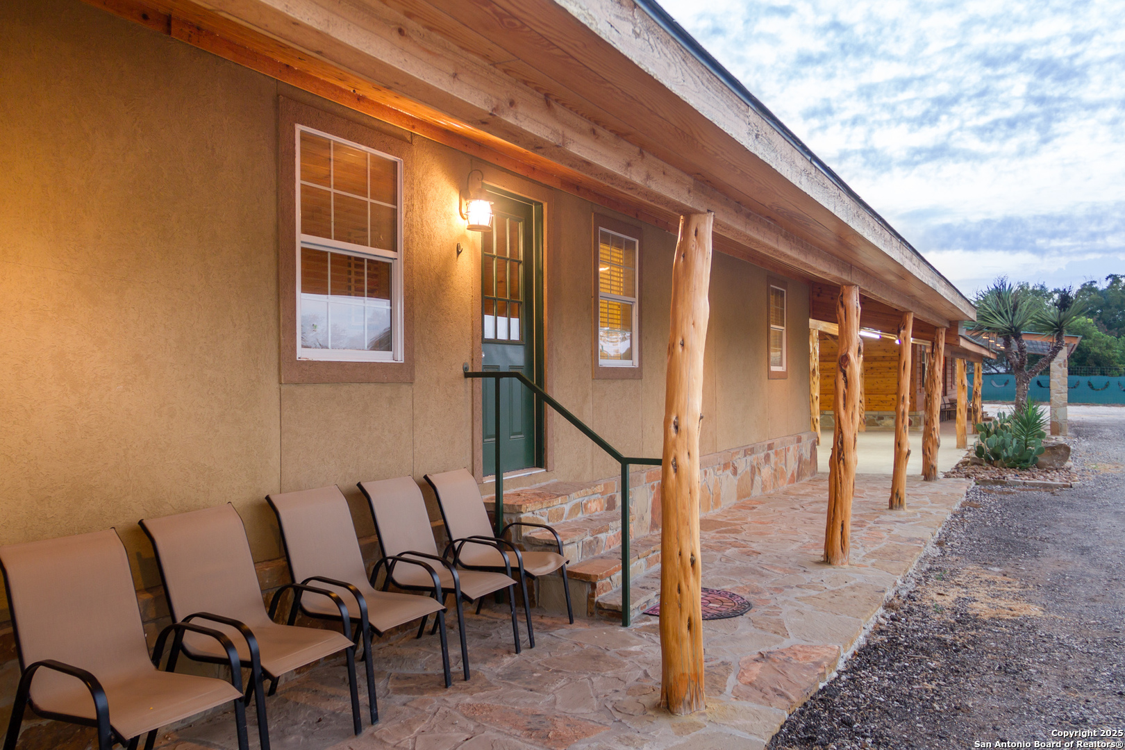 20250 Interstate 35 Access Road Lytle, TX 78052 - Photo 25 of 48 a view of a patio with table and chairs and floor to ceiling window