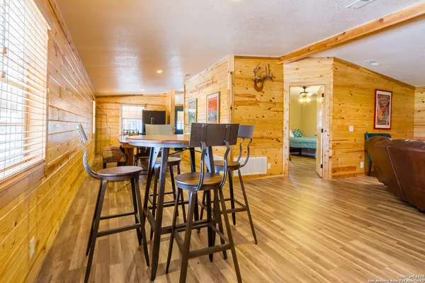 a view of a dining room with furniture and wooden floor