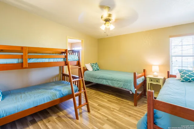 a bedroom with furniture and a wooden floor