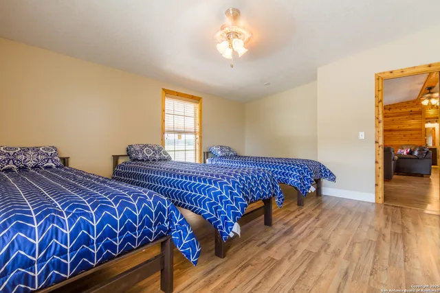 a bedroom with bed and wooden floor