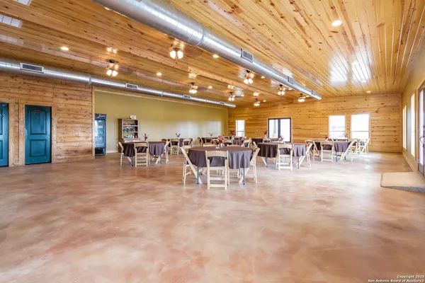 a view of a dining room with lots of furniture a chandelier