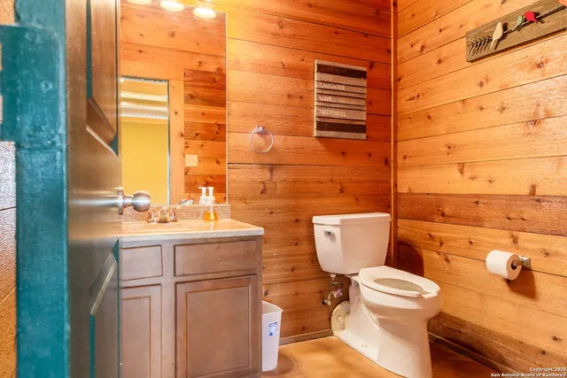 a bathroom with a toilet sink and mirror
