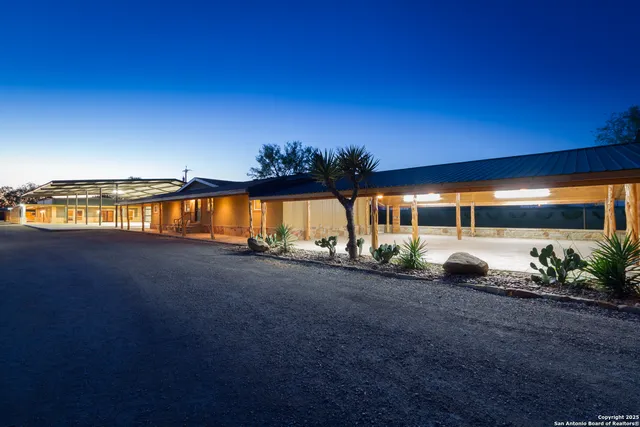 a view of a house with backyard and patio