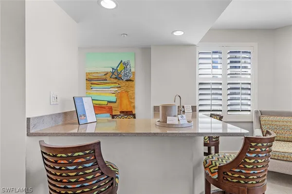a dining room with furniture and window