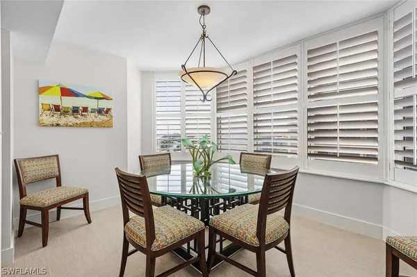 a dining room with furniture and window
