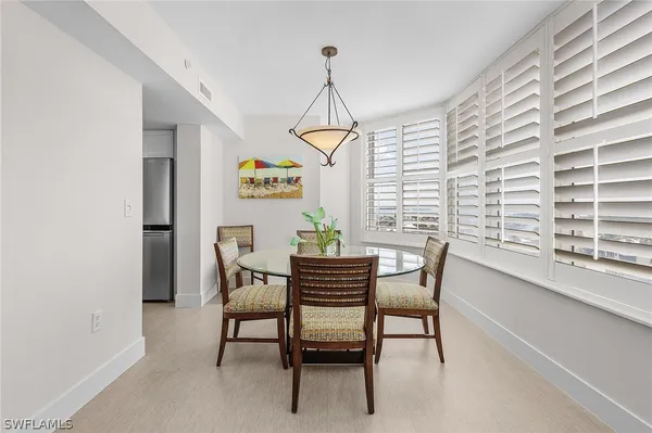 a dining room with furniture and window