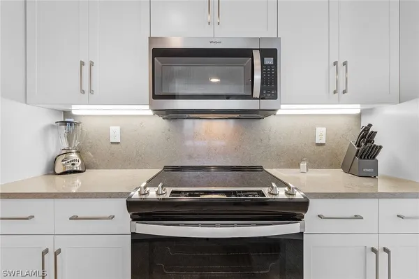 a stove top oven sitting inside of a kitchen