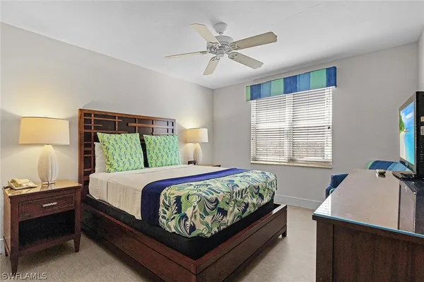 a bed room with a bed and a window