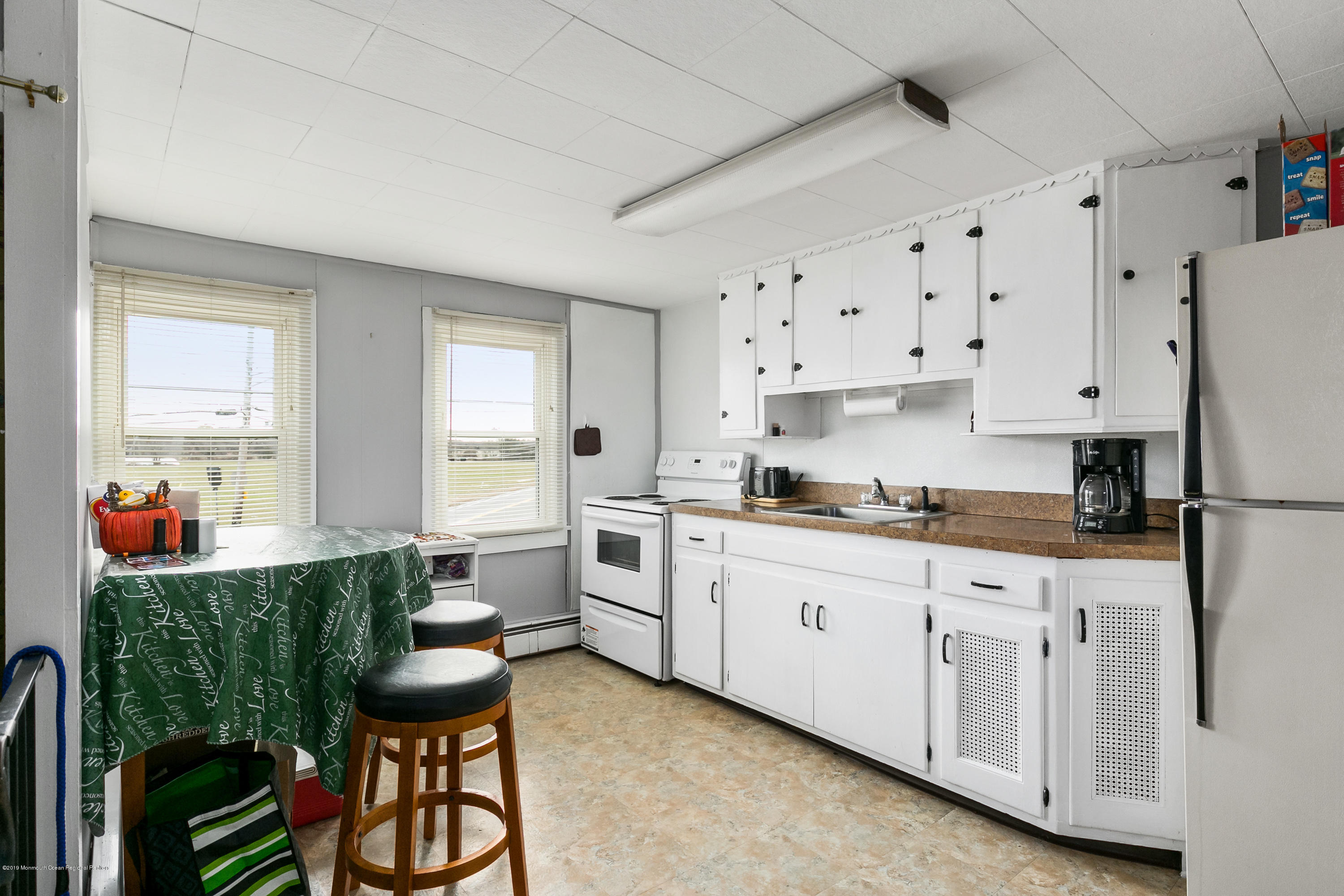 880 Monmouth Road Cream Ridge, NJ 08514 - Photo 26 of 45 a kitchen with white cabinets and white appliances