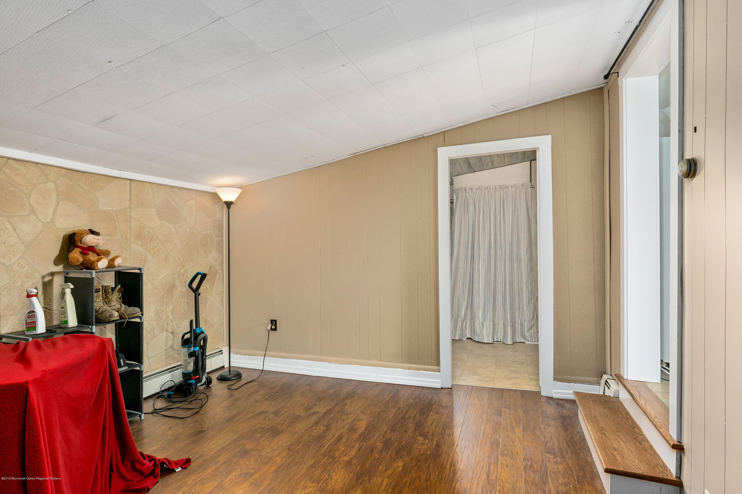 880 Monmouth Road Cream Ridge, NJ 08514 - Photo 32 of 45 an empty room with wooden floor and windows