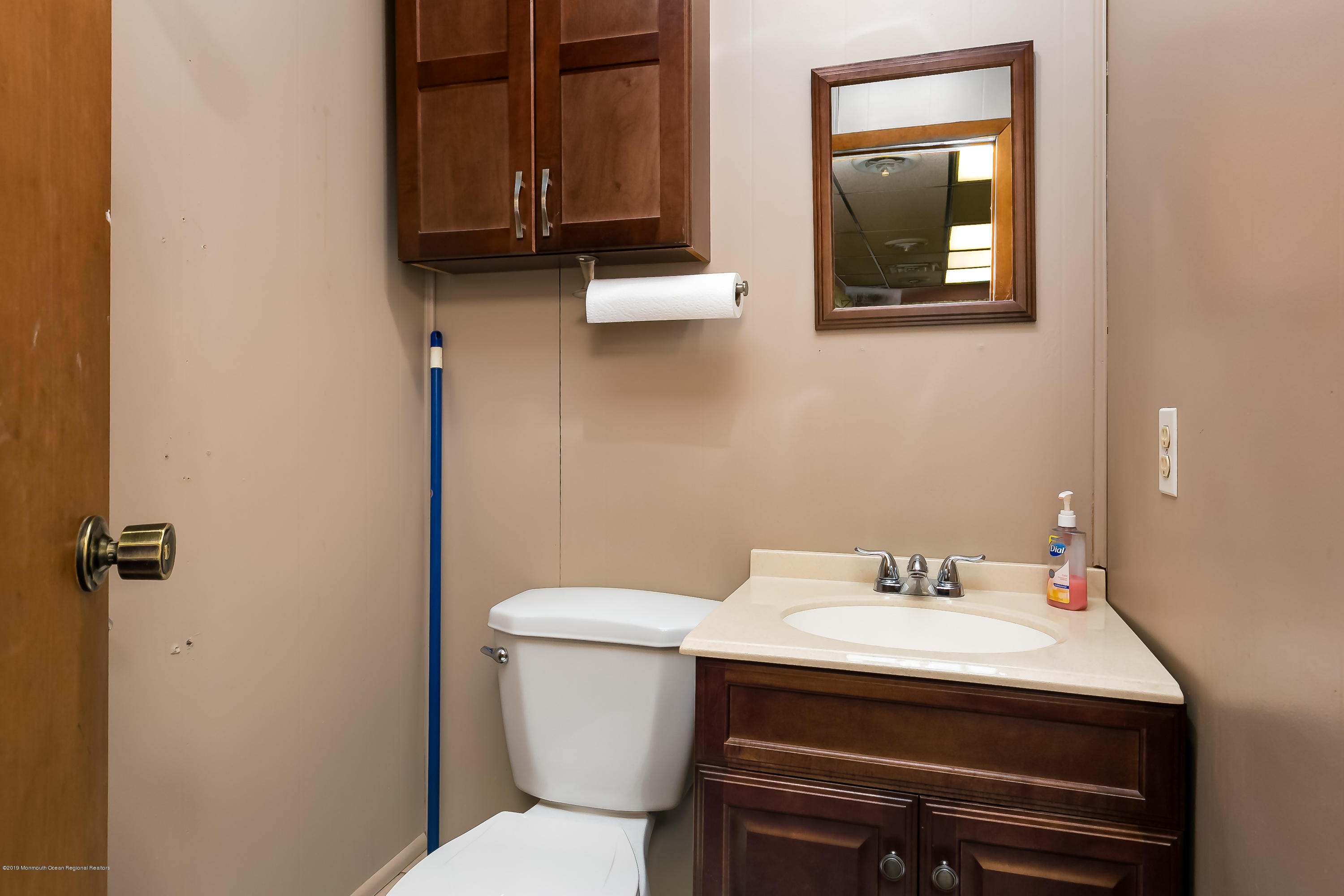 880 Monmouth Road Cream Ridge, NJ 08514 - Photo 38 of 45 a bathroom with a toilet a sink and mirror