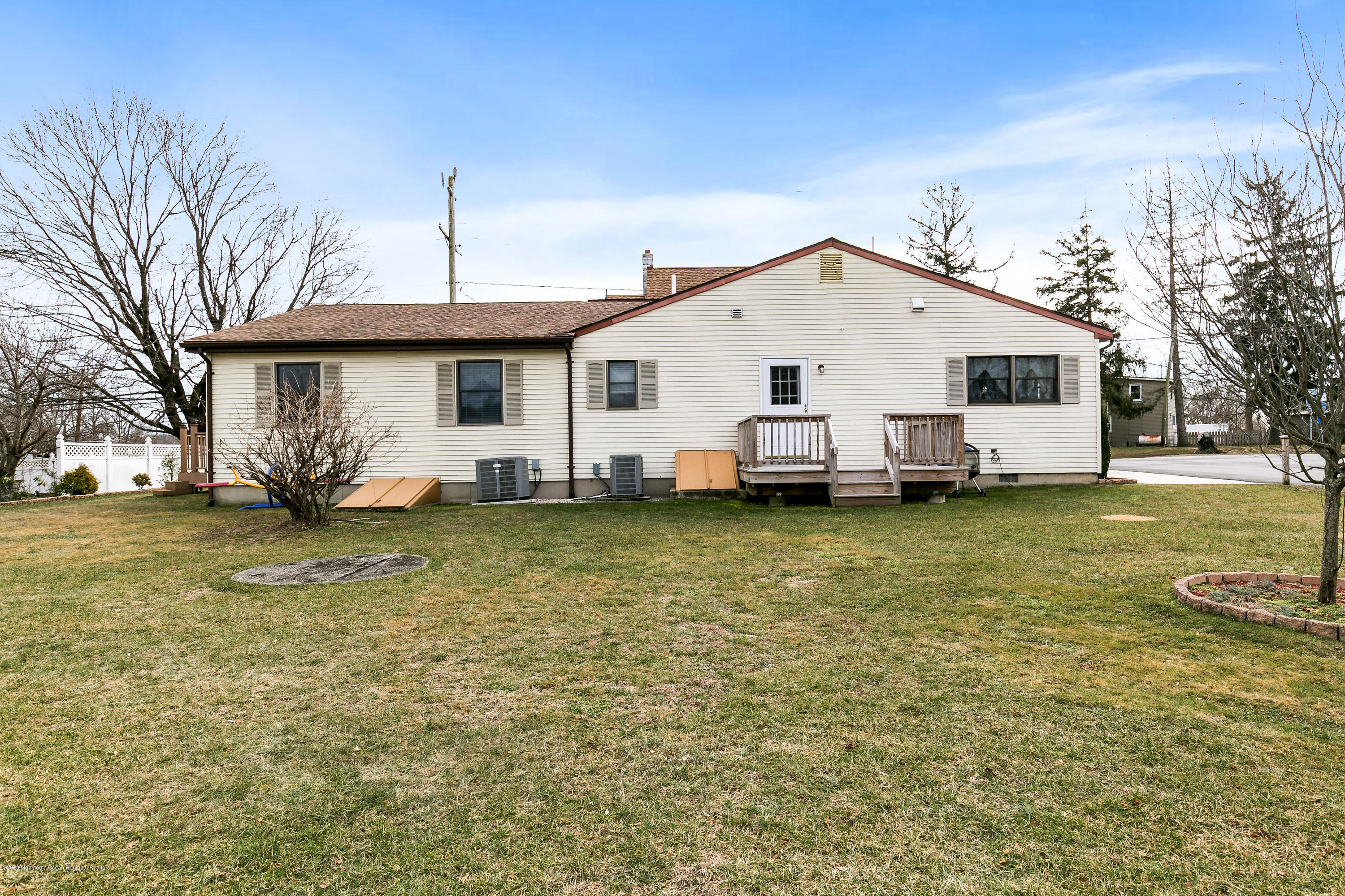 880 Monmouth Road Cream Ridge, NJ 08514 - Photo 43 of 45 a view of a white house with a big yard and large trees