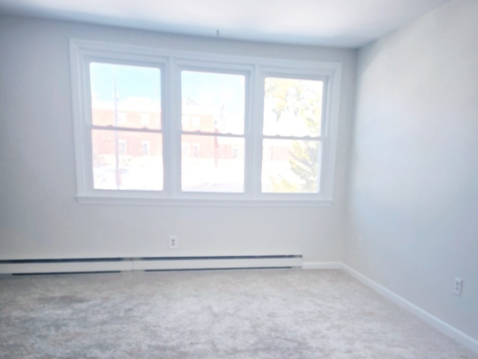 567 Main Street, Unit 2 Shrewsbury, MA 01545 - Photo 3 of 7 an empty room with a window