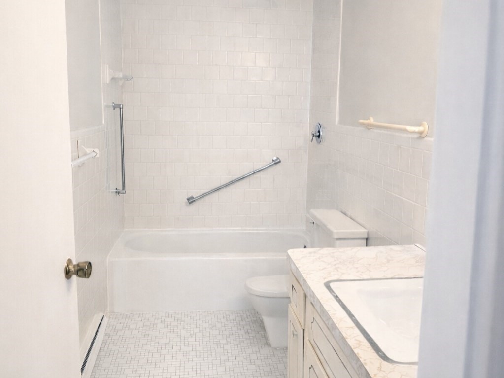 567 Main Street, Unit 2 Shrewsbury, MA 01545 - Photo 4 of 7 a bathroom with a sink a toilet and shower