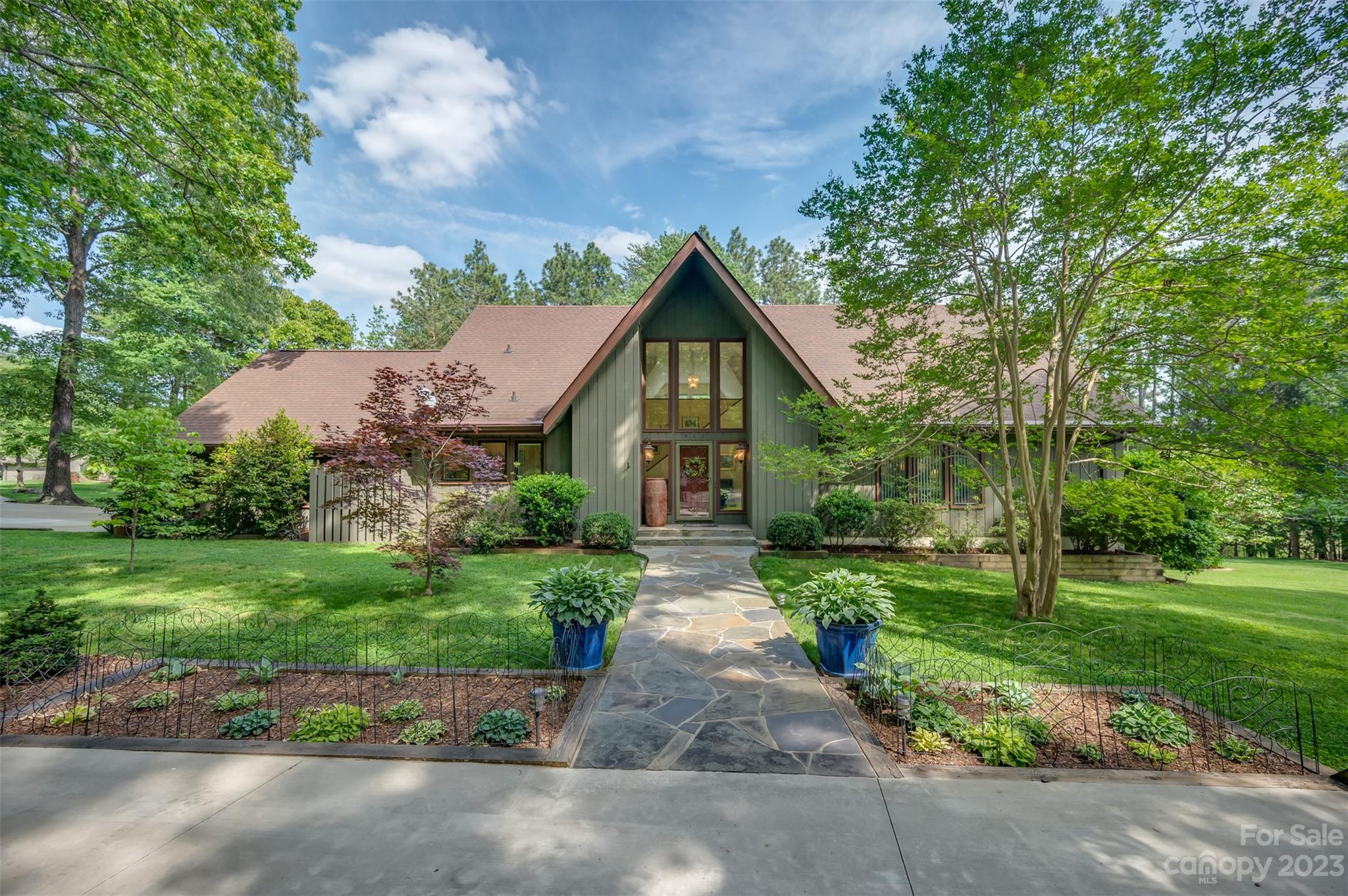 900 Club Road Tryon, NC 28782 - Photo 1 of 48 a front view of a house with garden