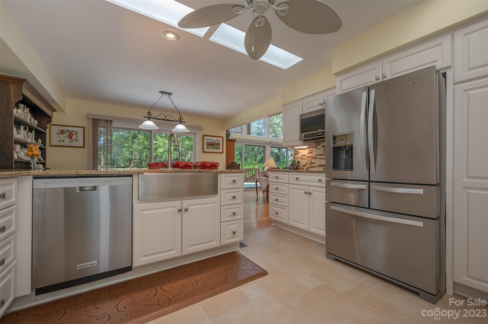 900 Club Road Tryon, NC 28782 - Photo 12 of 48 a kitchen with white cabinets and stainless steel appliances