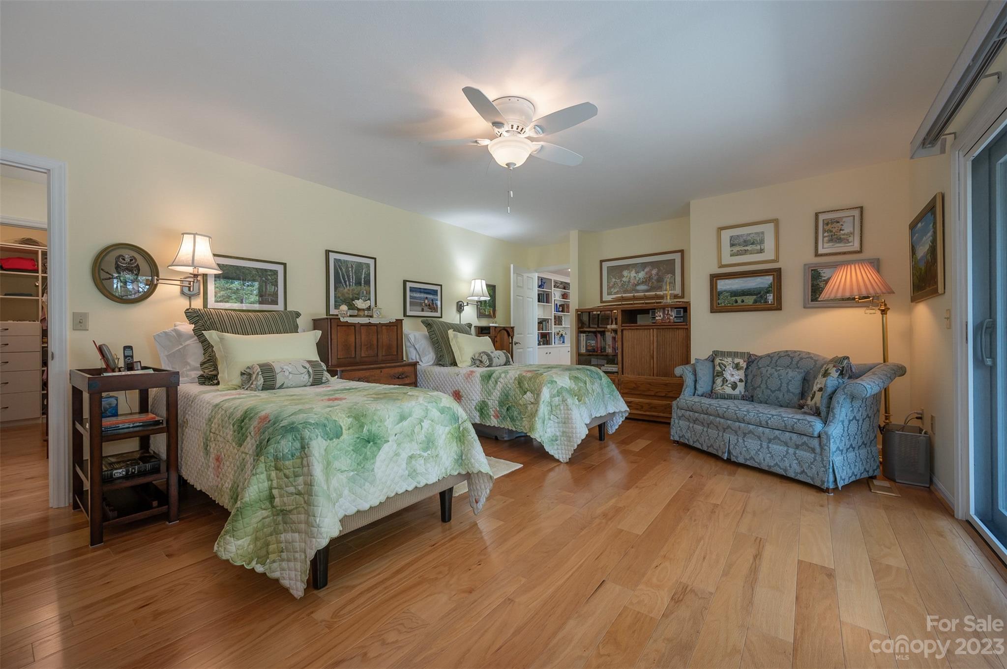 900 Club Road Tryon, NC 28782 - Photo 17 of 48 a spacious bedroom with a bed and a chandelier