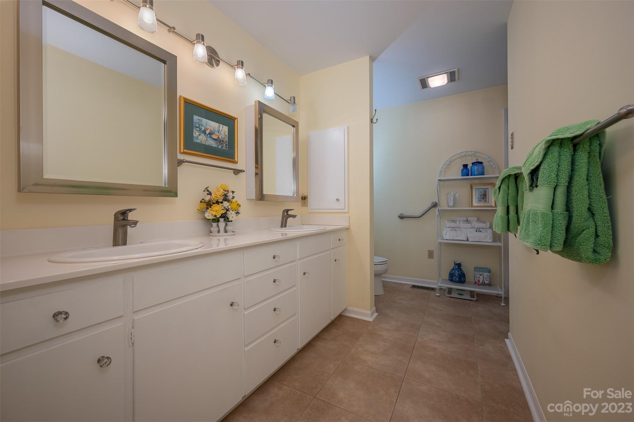 900 Club Road Tryon, NC 28782 - Photo 19 of 48 a en suite bathroom with a double vanity sink and mirror