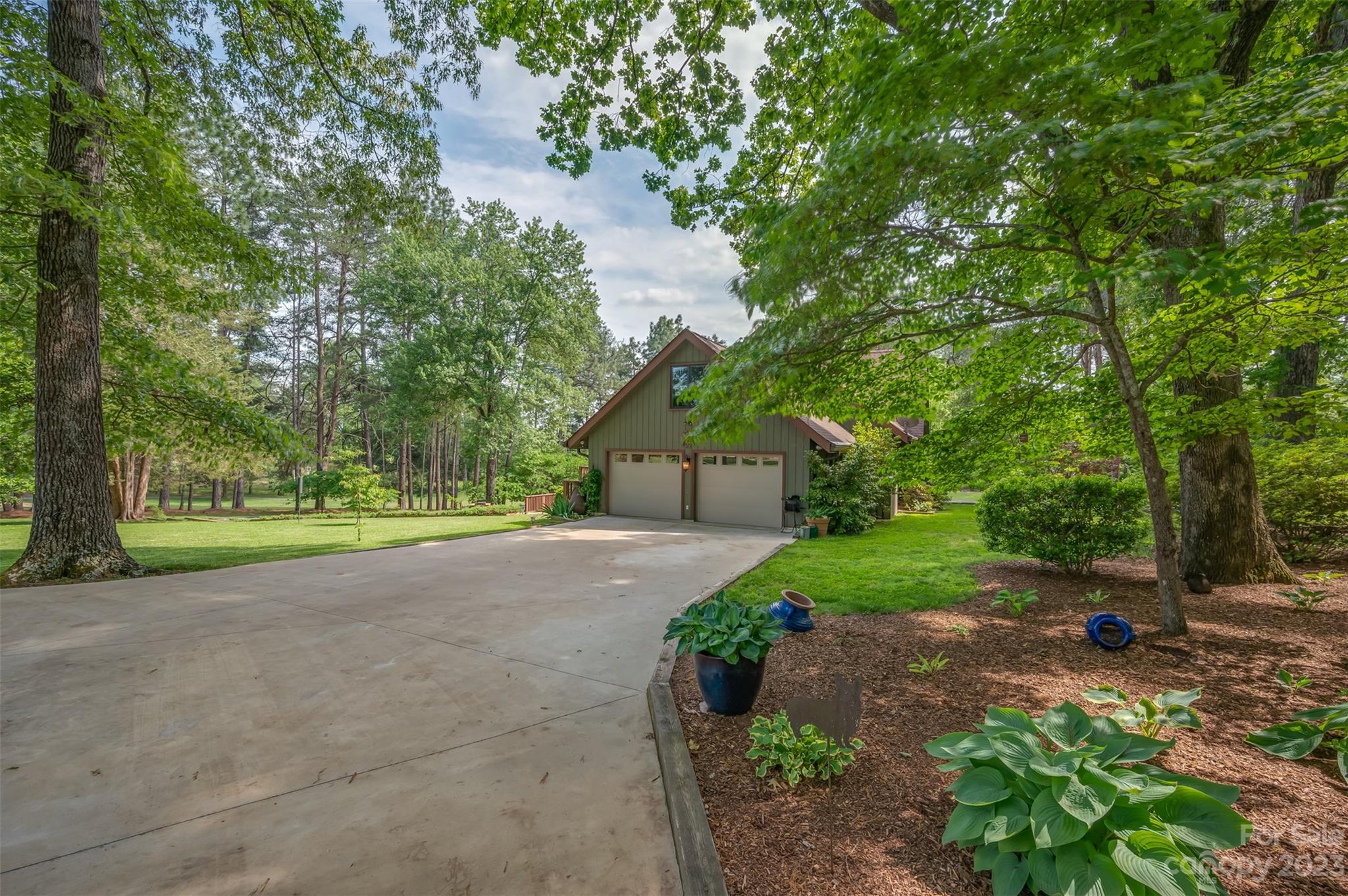 900 Club Road Tryon, NC 28782 - Photo 42 of 48 a view of a street with a house and large trees