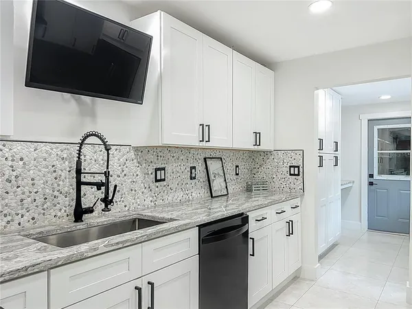 a bathroom with a granite countertop sink a toilet and a mirror