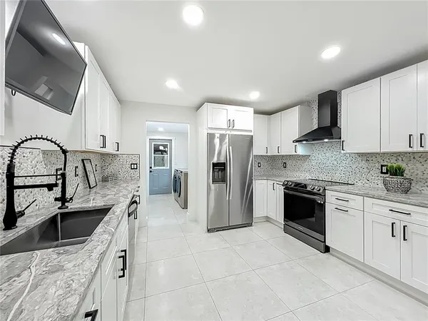 a view of a kitchen with furniture and wooden floor