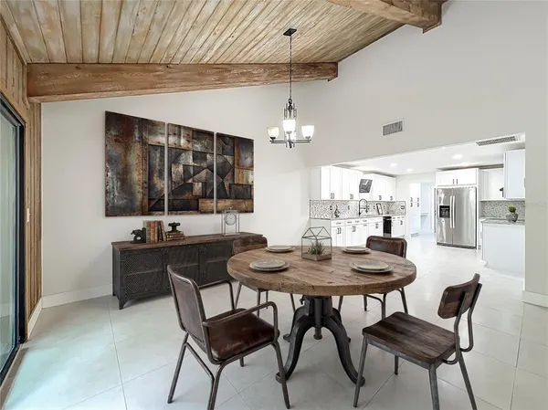 a kitchen with stainless steel appliances granite countertop a stove and a white cabinets
