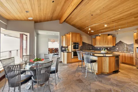 a kitchen with kitchen island granite countertop a counter top space a sink and cabinets