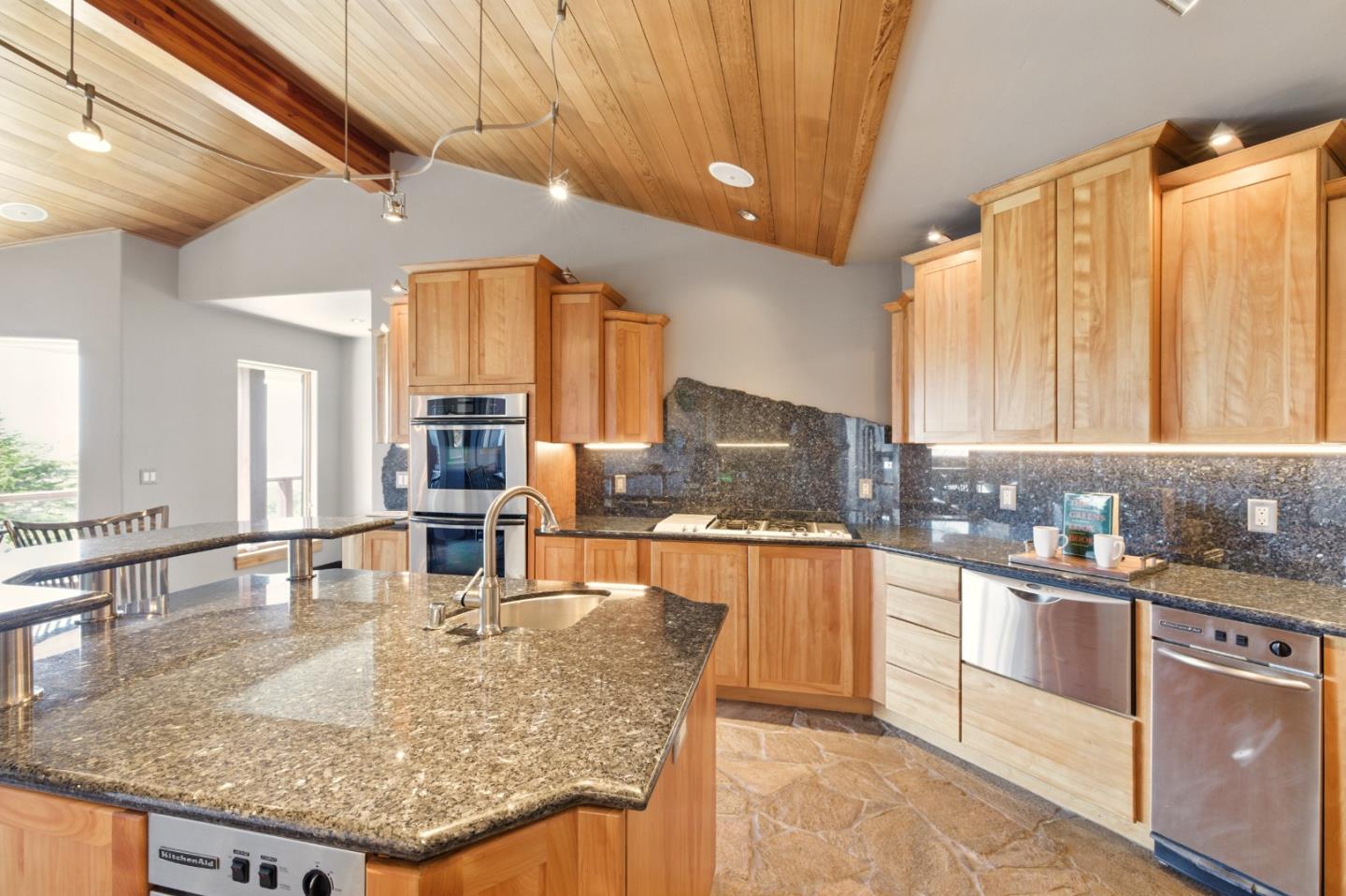 31475 Highway 1 Carmel, CA 93923 - Photo 12 of 43 a kitchen with kitchen island granite countertop a counter top space a sink and cabinets