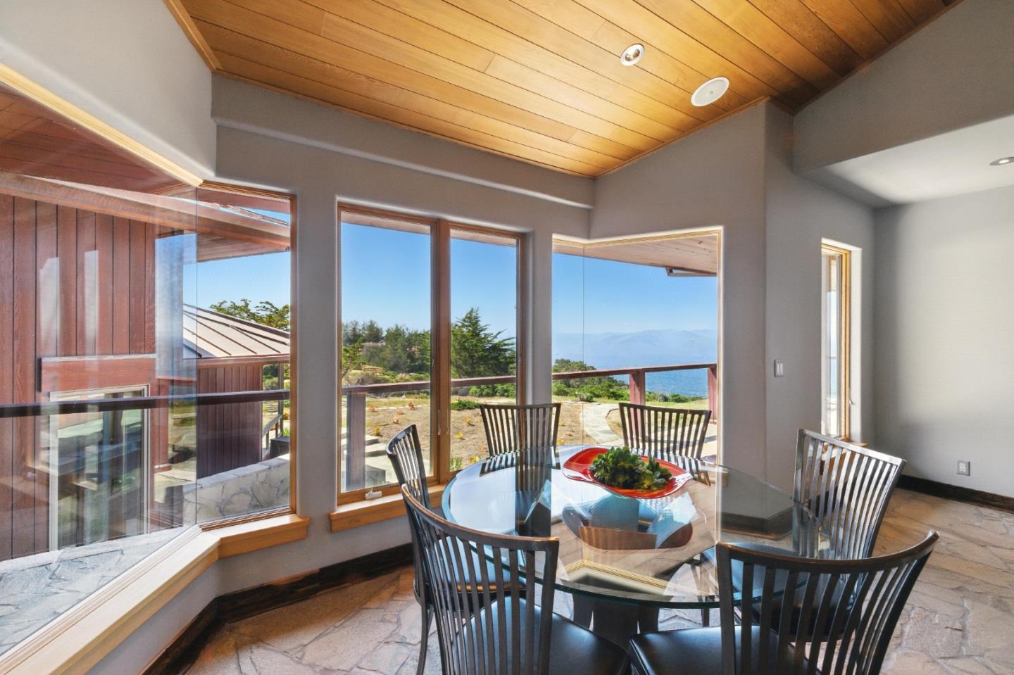31475 Highway 1 Carmel, CA 93923 - Photo 13 of 43 a view of a dining room with furniture wooden floor and glass door