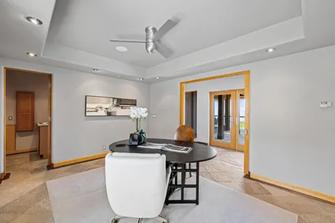 a bed sitting in a bedroom next to a large window