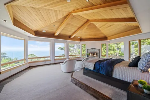 a bed room with a bed and large window