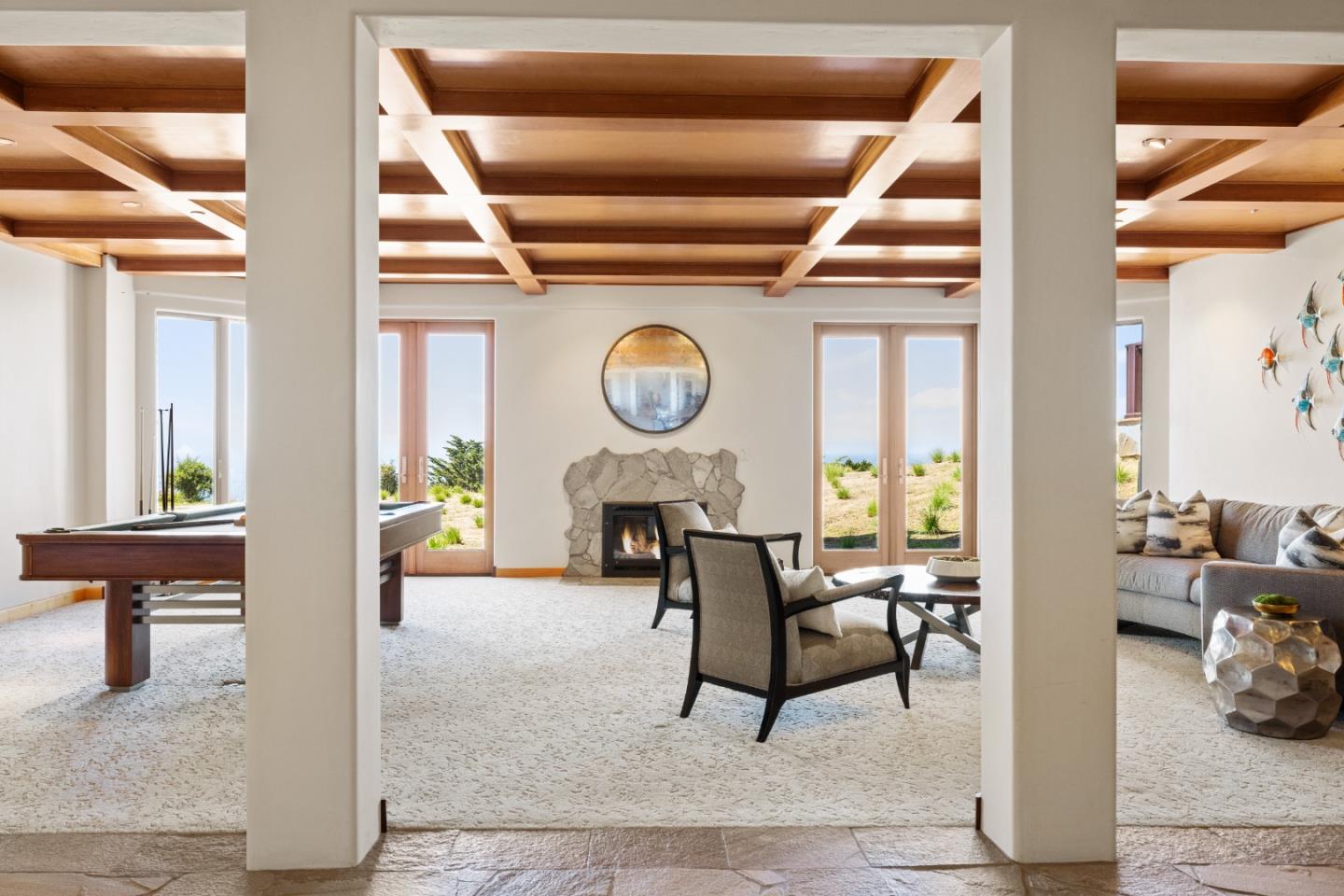 31475 Highway 1 Carmel, CA 93923 - Photo 30 of 43 a living room with furniture a clock and a large window