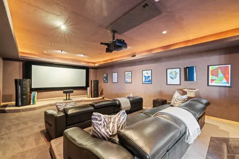 a living room with furniture a fireplace and a large window