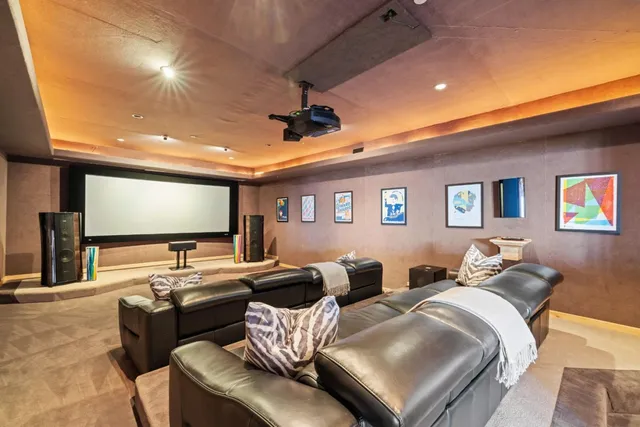a living room with furniture a fireplace and a large window