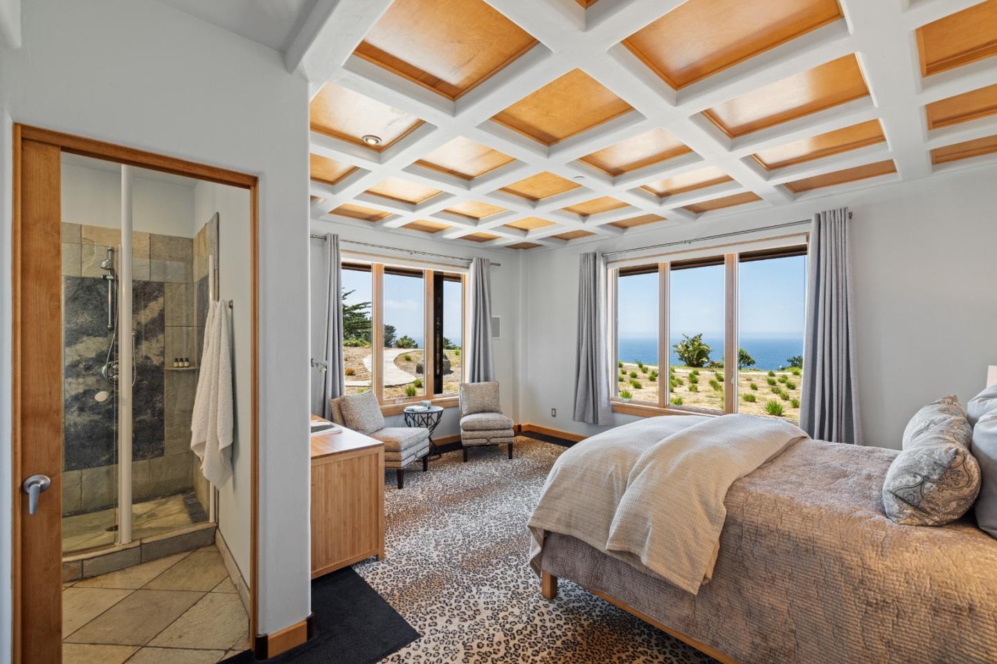 31475 Highway 1 Carmel, CA 93923 - Photo 36 of 43 a bedroom with a bed and a chandelier