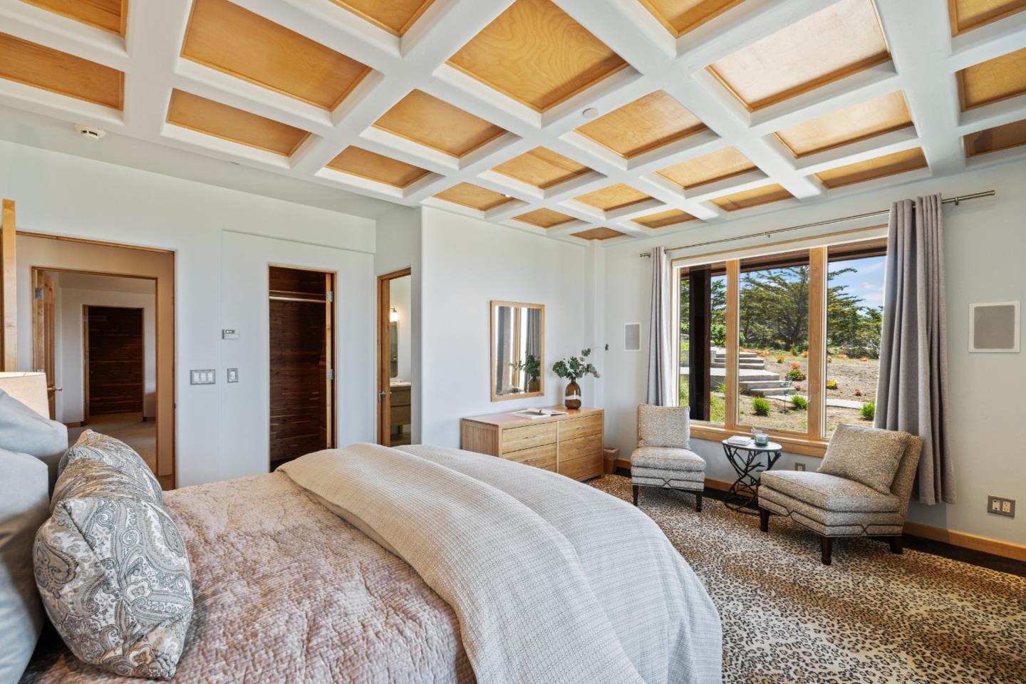 31475 Highway 1 Carmel, CA 93923 - Photo 37 of 43 a bedroom with a bed couch and large window with outer view