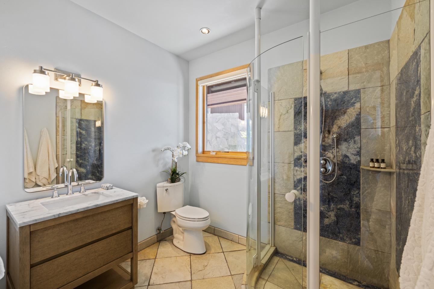 31475 Highway 1 Carmel, CA 93923 - Photo 38 of 43 a bathroom with a double vanity sink toilet and shower