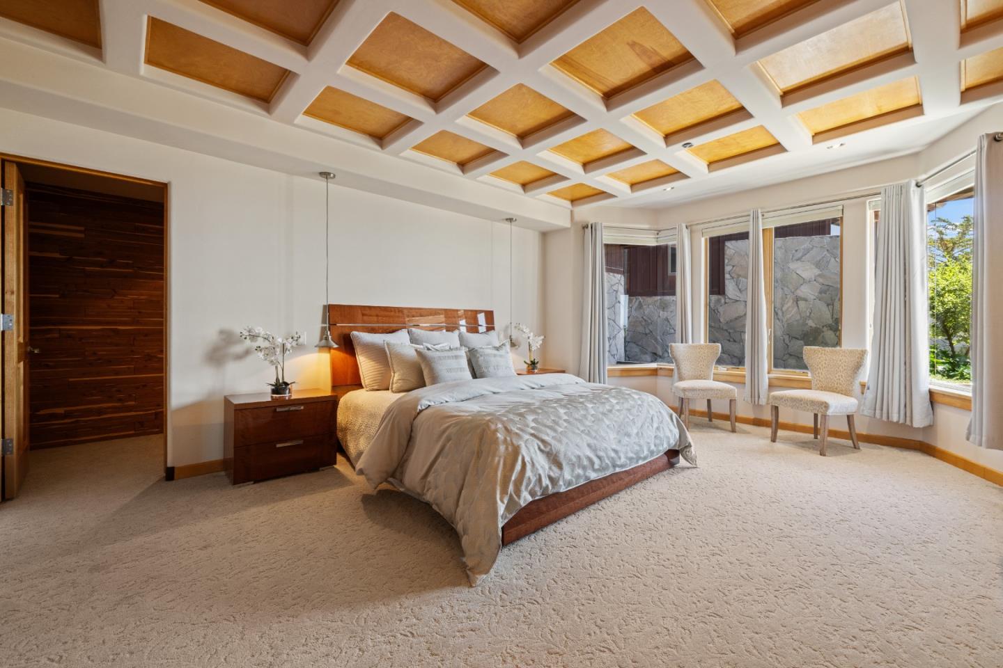 31475 Highway 1 Carmel, CA 93923 - Photo 39 of 43 a spacious bedroom with a bed and a large window