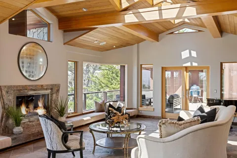 a living room with a large window a table and chairs