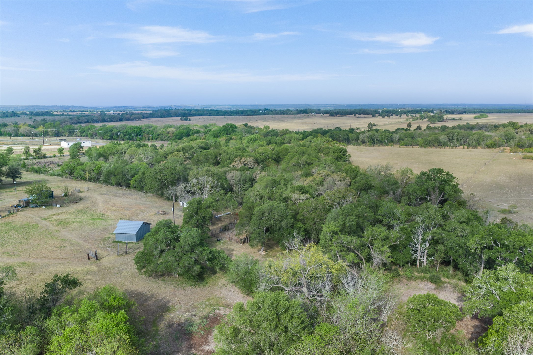 579 Lower Elgin Road Elgin, TX 78621 - Photo 35 of 40 a view of a big yard with lots of green space and fog
