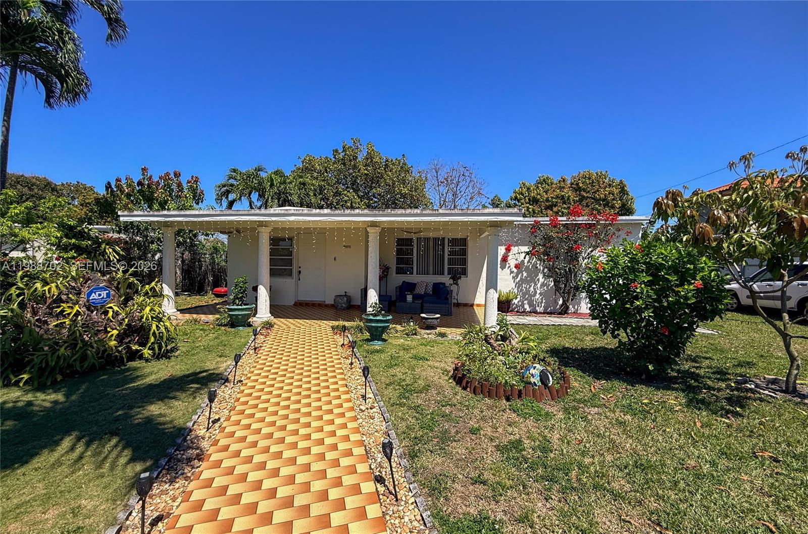 9971 Southwest 41st Terrace Miami, FL 33165 - Photo 1 of 21 a front view of a house with garden