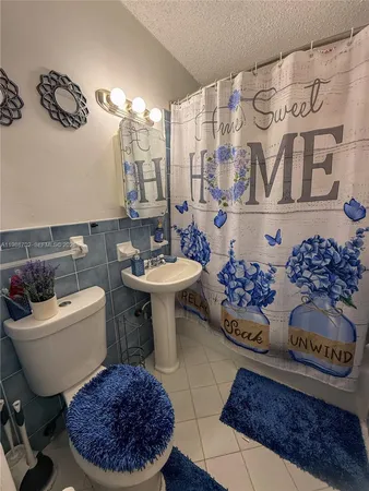 a bathroom with a toilet a sink and a mirror