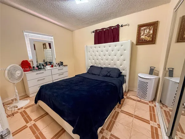 a bedroom with bed and wooden floor
