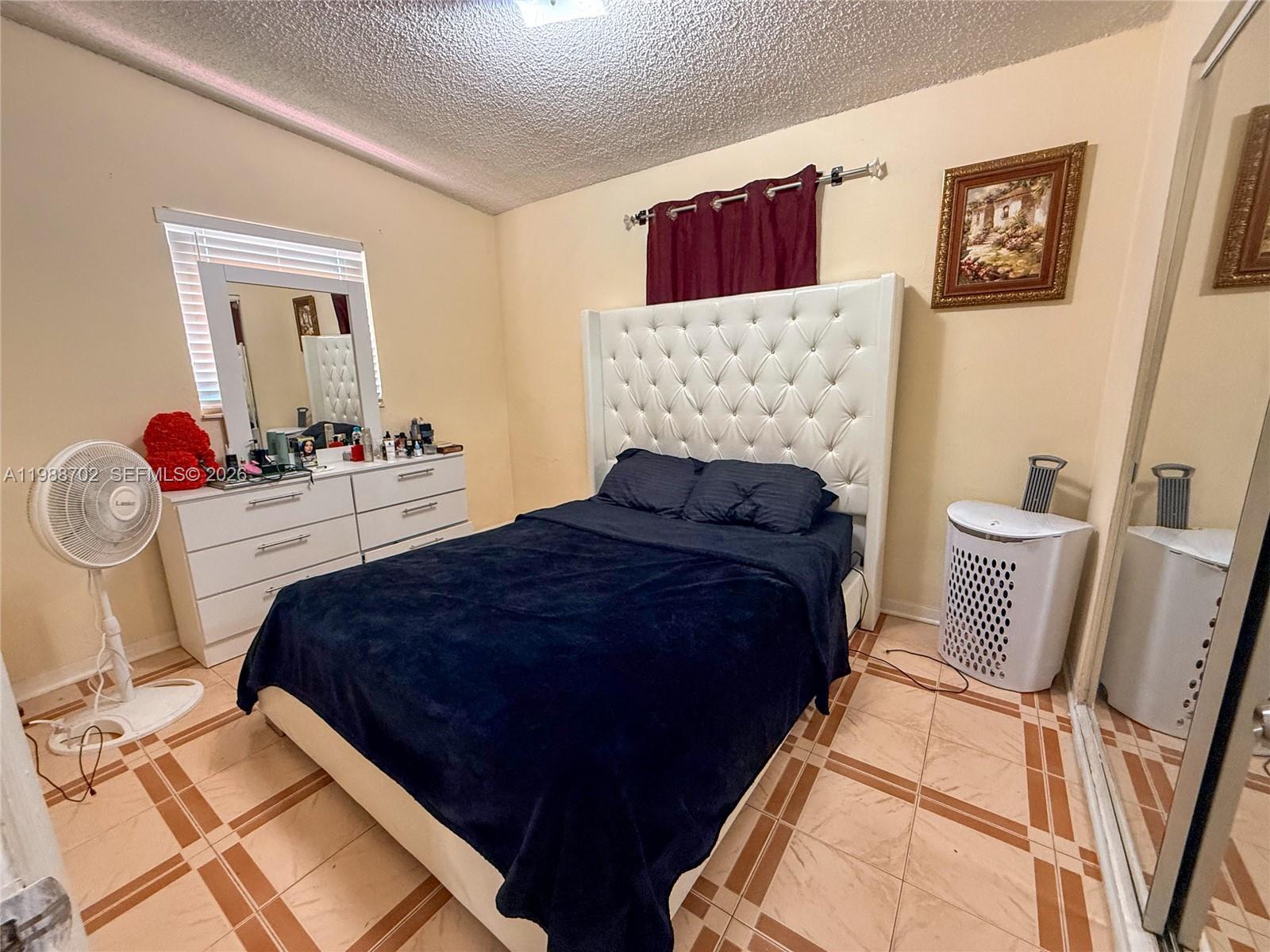 9971 Southwest 41st Terrace Miami, FL 33165 - Photo 15 of 21 a bedroom with bed and wooden floor