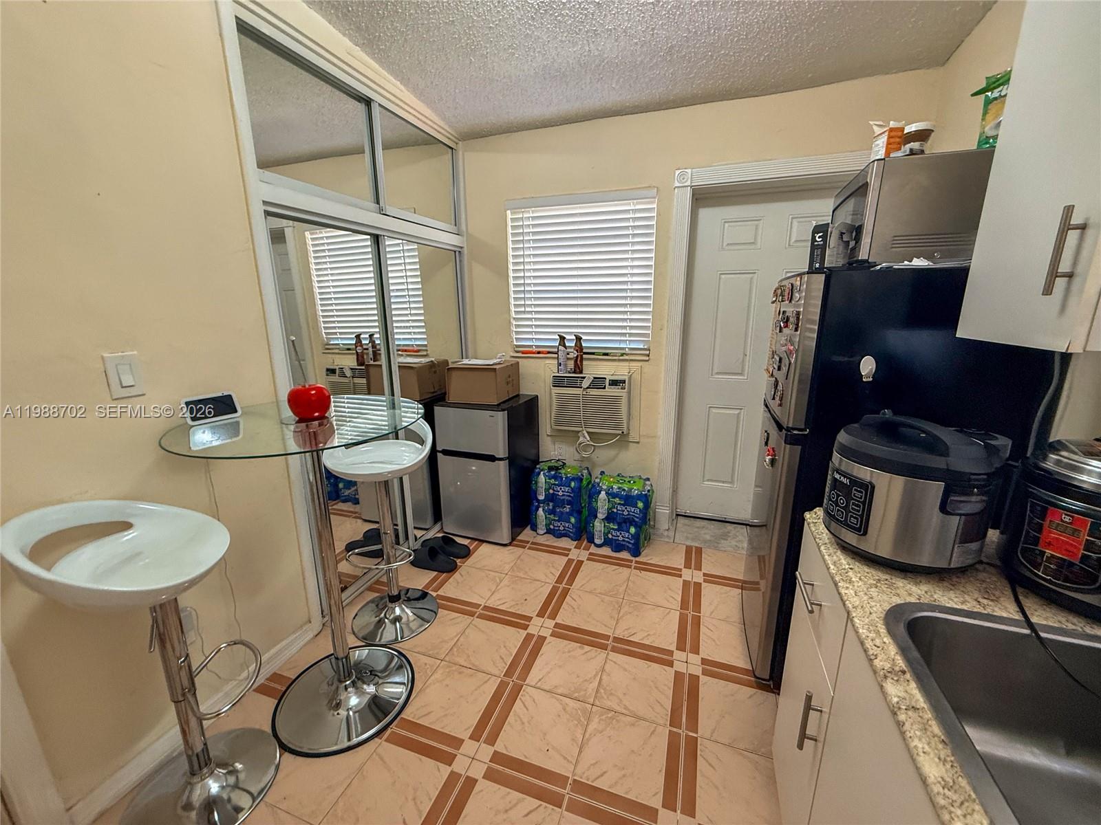 9971 Southwest 41st Terrace Miami, FL 33165 - Photo 16 of 21 a very nice looking dining room with a table and chairs in it