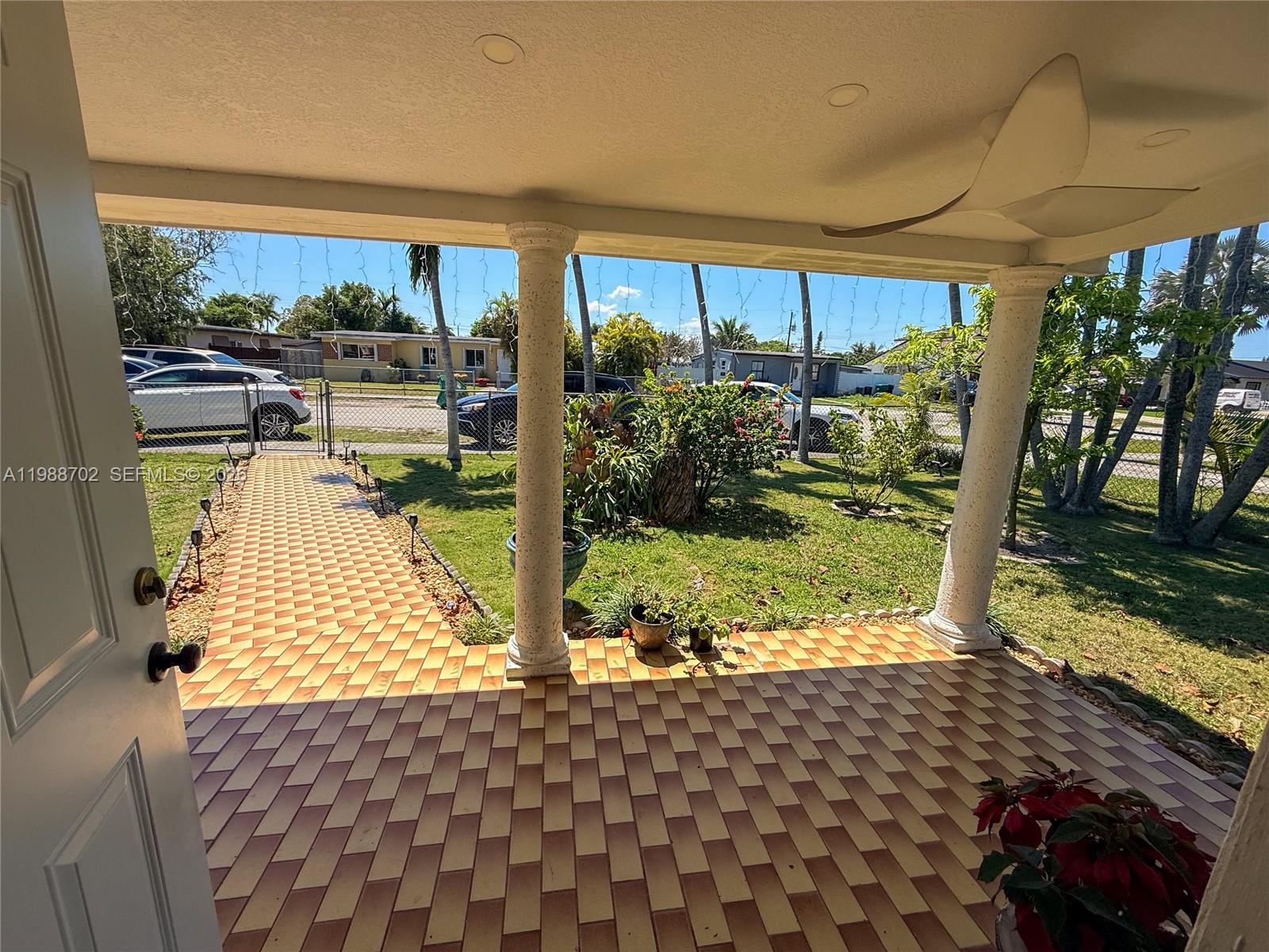 9971 Southwest 41st Terrace Miami, FL 33165 - Photo 17 of 21 a front view of a house with garden