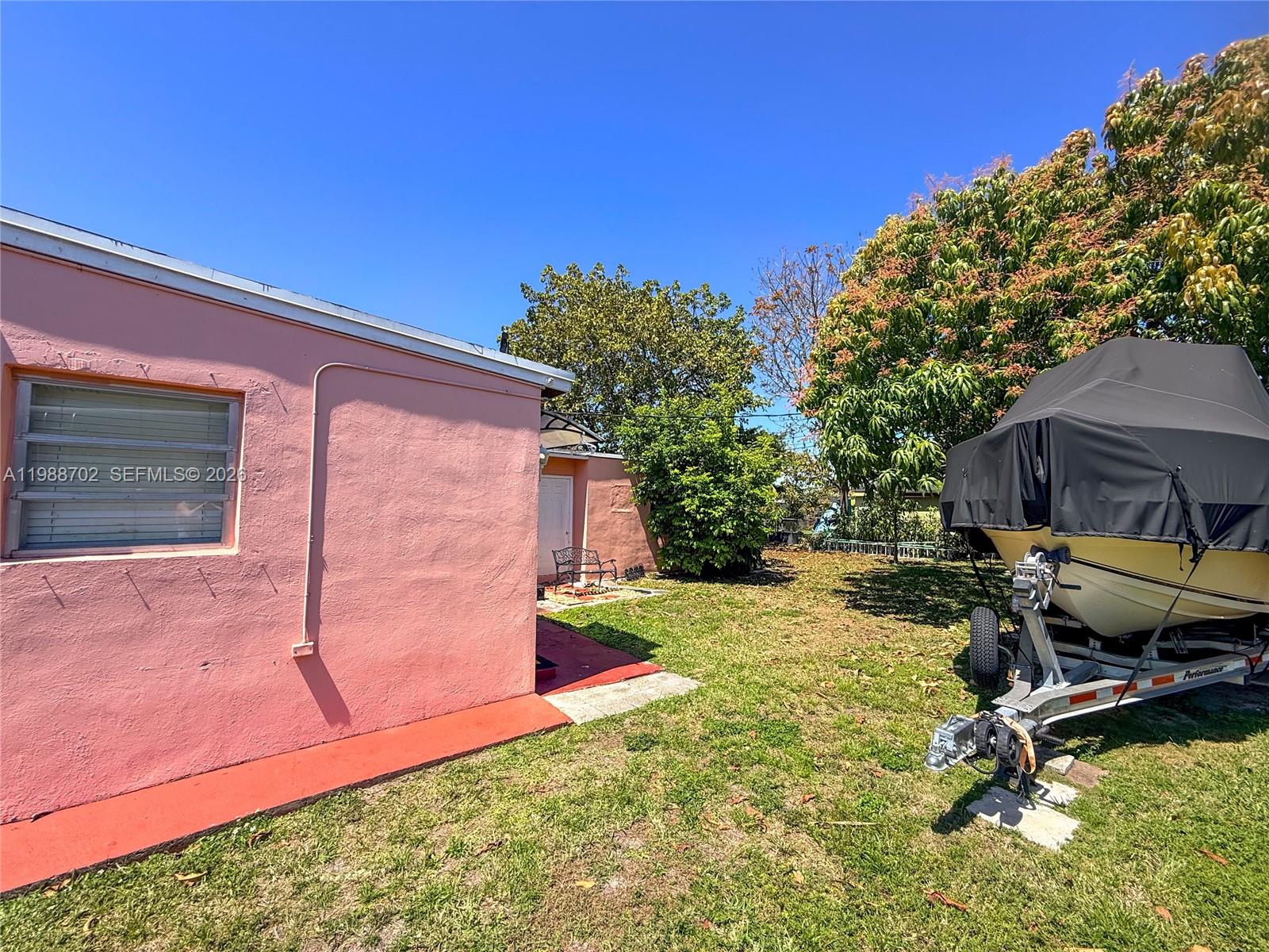 9971 Southwest 41st Terrace Miami, FL 33165 - Photo 20 of 21 a view of backyard with a table and chair